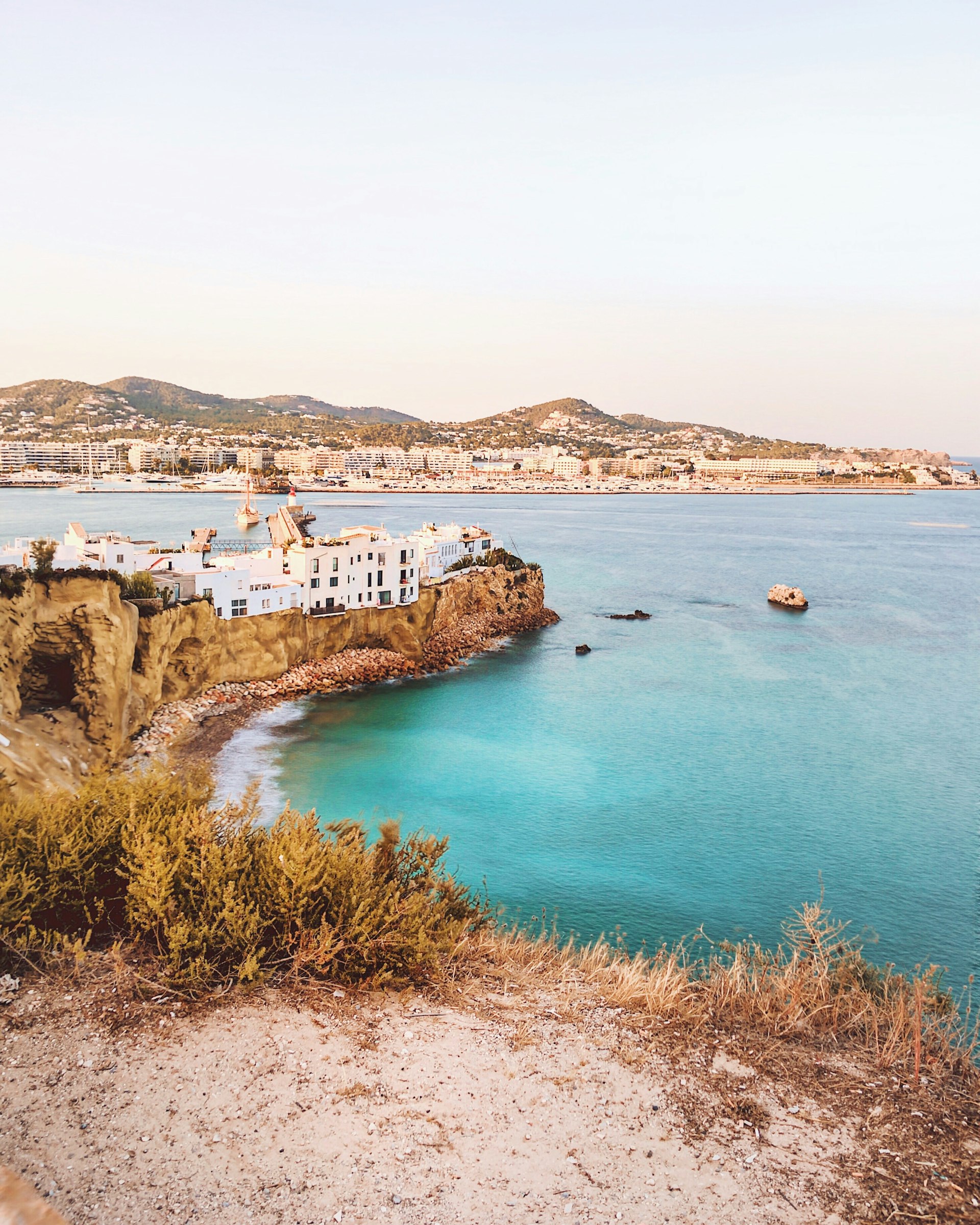 Whitewashed houses on a cliff along the Ibiza coast